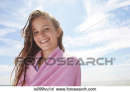 Stock Image - Girl with wet hair, wrapped in towel. Fotosearch
