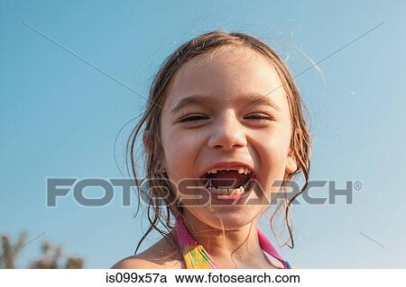 Stock Image - Happy girl against blue sky. Fotosearch