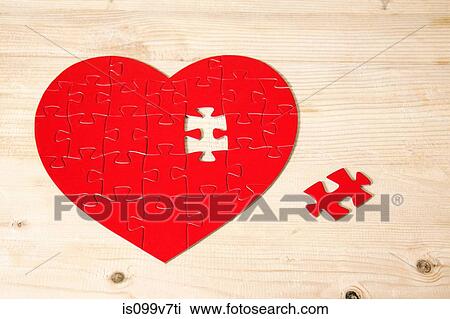 Stock Image - Heart shaped jigsaw puzzle with missing piece. Fotosearch
