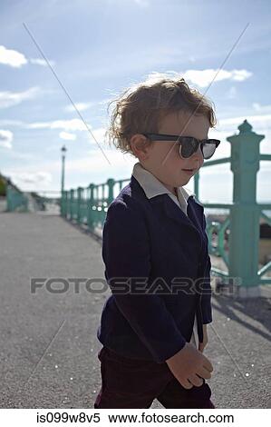 Little boy on promenade, wearing mod style clothing with sunglasses View Large Photo Image Stock Photography - Little boy on promenade, wearing mod style clothing with sunglasses. Fotosearch