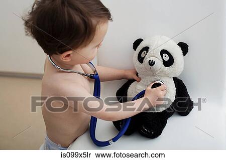 Stock Photography - Little boy using stethoscope on panda toy. Fotosearch