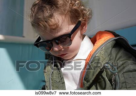 Stock Photo - Little boy wearing mod style sunglasses and parka. Fotosearch