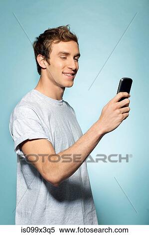Man holding smartphone View Large Photo Image Stock Photography - Man holding smartphone. Fotosearch