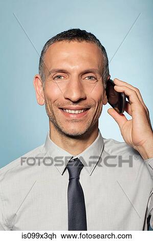 Stock Image - Man on smartphone. Fotosearch