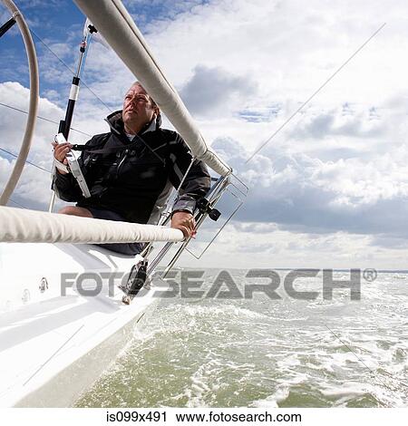 Man on yacht, with navigation aid View Large Photo Image Stock Image - Man on yacht, with navigation aid. Fotosearch
