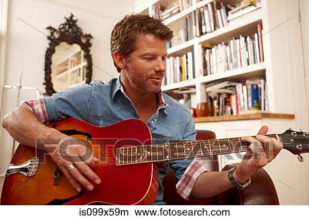 Picture - Man playing guitar. Fotosearch