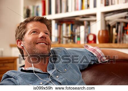 Stock Image - Man wearing earphones. Fotosearch