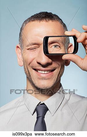 Man with smartphone over eye View Large Photo Image Stock Image - Man with smartphone over eye. Fotosearch