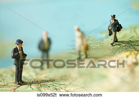 Miniature businessmen on a map View Large Photo Image Stock Photograph - Miniature businessmen on a map. Fotosearch