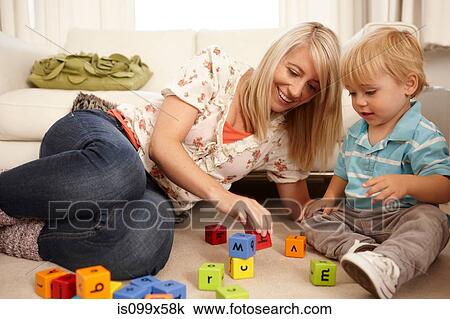 Mother and son playing with alphabet blocks View Large Photo Image Stock Image - Mother and son playing with alphabet blocks. Fotosearch
