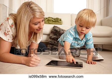 Mother and son using digital tablet View Large Photo Image Picture - Mother and son using digital tablet. Fotosearch