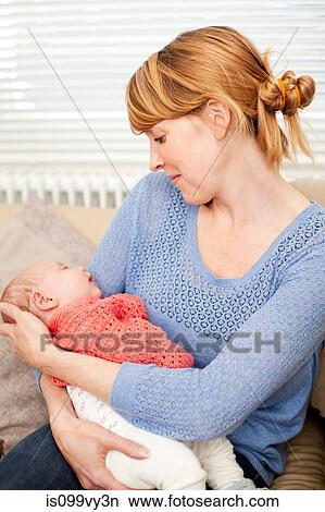 Mother holding newborn daughter View Large Photo Image Picture - Mother holding newborn daughter. Fotosearch