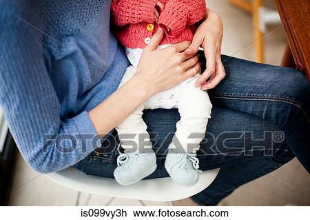 Mother holding newborn daughter, cropped image View Large Photo Image Stock Image - Mother holding newborn daughter, cropped image. Fotosearch
