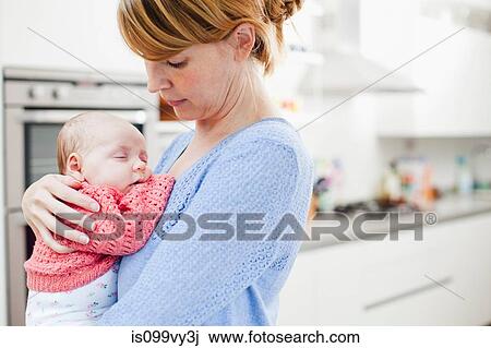 Mother holding newborn daughter View Large Photo Image Stock Image - Mother holding newborn daughter. Fotosearch