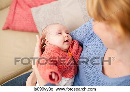 Stock Photography - Mother holding newborn daughter. Fotosearch