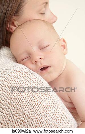 Mother with newborn baby sleeping on shoulder View Large Photo Image Stock Image - Mother with newborn baby sleeping on shoulder. Fotosearch