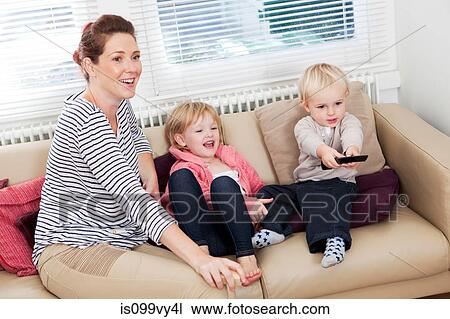 Mother with two children watching television View Large Photo Image Stock Image - Mother with two children watching television. Fotosearch