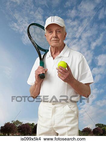 Picture - Portrait of a senior man with tennis gear. Fotosearch