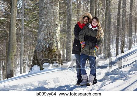 Picture - Portrait of couple hugging, wearing winter clothes. Fotosearch