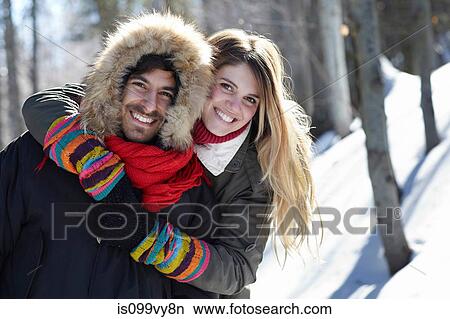 Portrait of couple hugging, wearing winter clothes View Large Photo Image Picture - Portrait of couple hugging, wearing winter clothes. Fotosearch