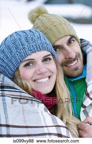 Portrait of couple wearing knit hats, wrapped in blanket View Large Photo Image Stock Photo - Portrait of couple wearing knit hats, wrapped in blanket. Fotosearch
