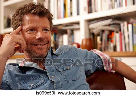 Stock Image - Portrait of man leaning on elbow. Fotosearch