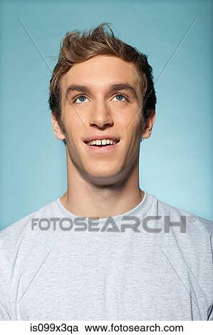 Stock Image - Portrait of man looking up. Fotosearch