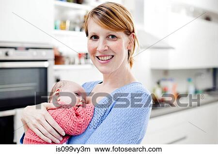 Portrait of mother holding newborn daughter View Large Photo Image Picture - Portrait of mother holding newborn daughter. Fotosearch