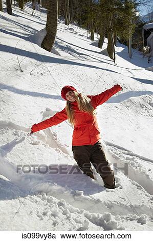 Portrait of woman wearing red coat in snow, arms out View Large Photo Image Stock Image - Portrait of woman wearing red coat in snow, arms out. Fotosearch