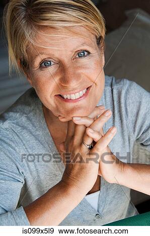 Portrait of woman with hands on chin View Large Photo Image Stock Photo - Portrait of woman with hands on chin. Fotosearch