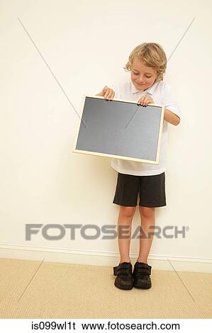 Schoolboy holding blank blackboard View Large Photo Image Stock Photograph - Schoolboy holding blank blackboard. Fotosearch