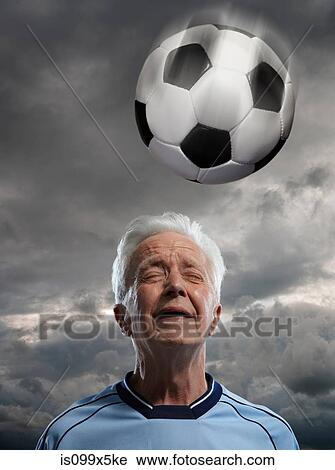 Senior man heading football View Large Photo Image Stock Image - Senior man heading football. Fotosearch