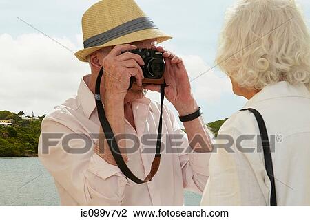 Senior man photographing wife View Large Photo Image Stock Image - Senior man photographing wife. Fotosearch