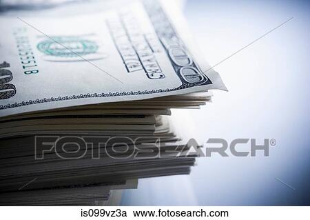 Stock Image - Stack of one hundred dollar bills. Fotosearch