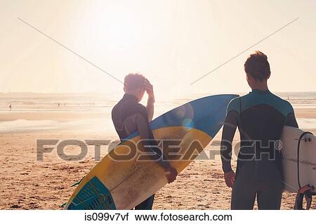 Surfers looking out towards sea View Large Photo Image Stock Image - Surfers looking out towards sea. Fotosearch