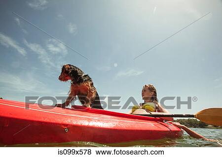 Teenage girl and pet dog in kayak View Large Photo Image Stock Photo - Teenage girl and pet dog in kayak. Fotosearch