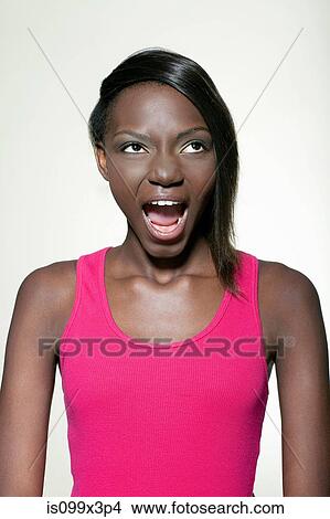 Picture - Teenage girl pulling faces. Fotosearch