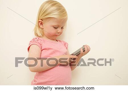 Toddler holding smartphone View Large Photo Image Stock Photo - Toddler holding smartphone. Fotosearch