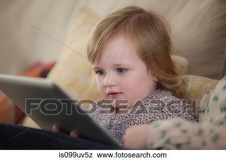 Stock Photo - Toddler looking at digital tablet. Fotosearch