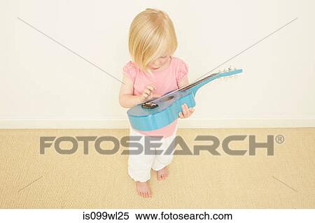 Toddler playing blue guitar View Large Photo Image Stock Photography - Toddler playing blue guitar. Fotosearch