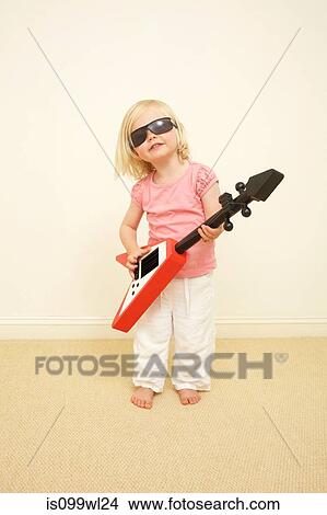 Toddler wearing sunglasses, playing guitar View Large Photo Image Picture - Toddler wearing sunglasses, playing guitar. Fotosearch