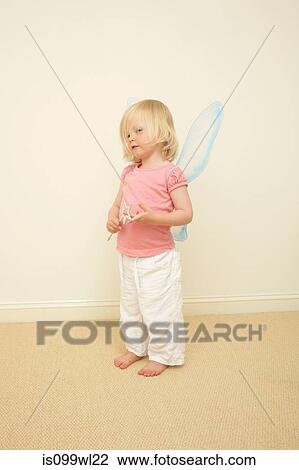 Toddler wearing wings, holding wand View Large Photo Image Stock Image - Toddler wearing wings, holding wand. Fotosearch