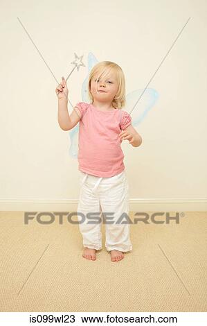 Toddler wearing wings, holding wand View Large Photo Image Stock Image - Toddler wearing wings, holding wand. Fotosearch