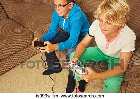 Two boys playing video game View Large Photo Image Picture - Two boys playing video game. Fotosearch