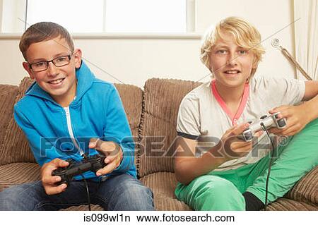 Two boys playing video game View Large Photo Image Picture - Two boys playing video game. Fotosearch