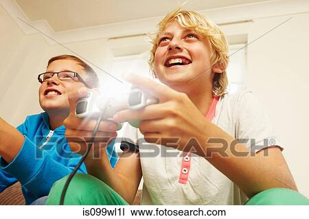 Two boys playing video game View Large Photo Image Stock Image - Two boys playing video game. Fotosearch