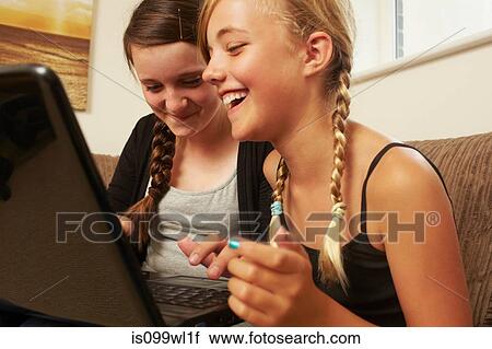 Stock Image - Two girls using laptop. Fotosearch