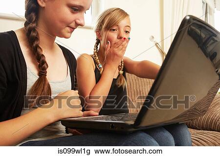 Two girls using laptop View Large Photo Image Stock Image - Two girls using laptop. Fotosearch