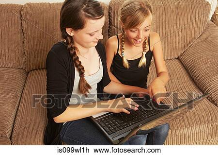 Two girls using laptop View Large Photo Image Stock Image - Two girls using laptop. Fotosearch