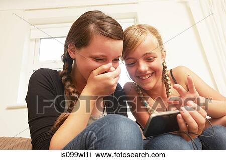 Stock Image - Two girls using smartphone. Fotosearch